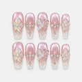 catalog: Long coffin press-on nails in pearly pink cat-eye fading to clear tips, with raised white 3D flowers and butterflies, pearls and crystal chain details.