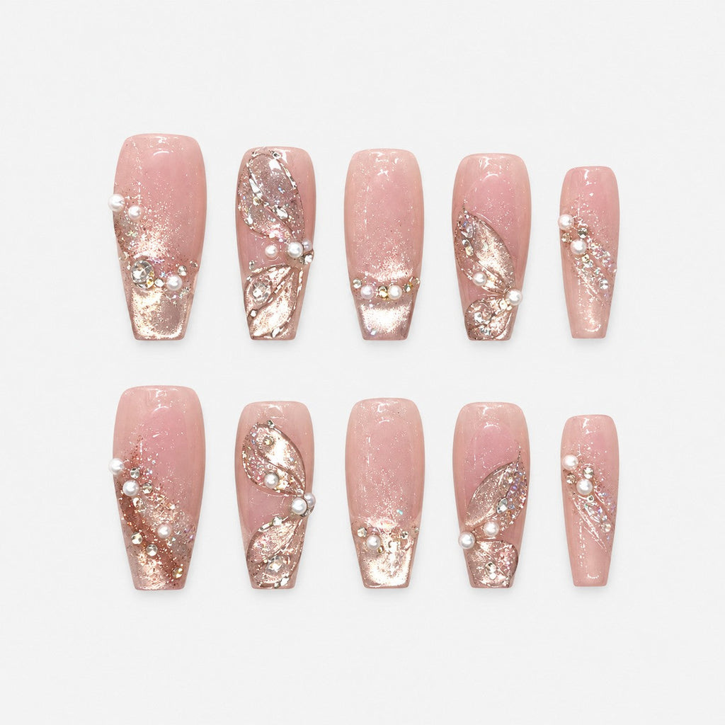catalog: Long pink sheer nails with sculpted glitter petals, small pearls and rhinestones over a shimmering base.