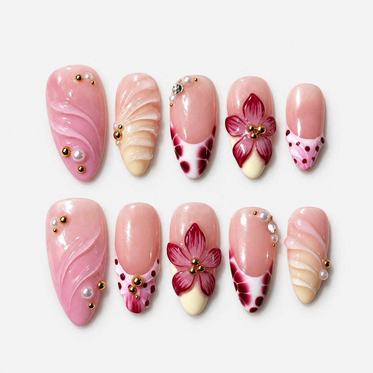 catalog: Medium almond press-on nails in soft pink with raised burgundy 3D flowers, wine-coloured speckled tips, carved wave texture, pearls and gold beads.