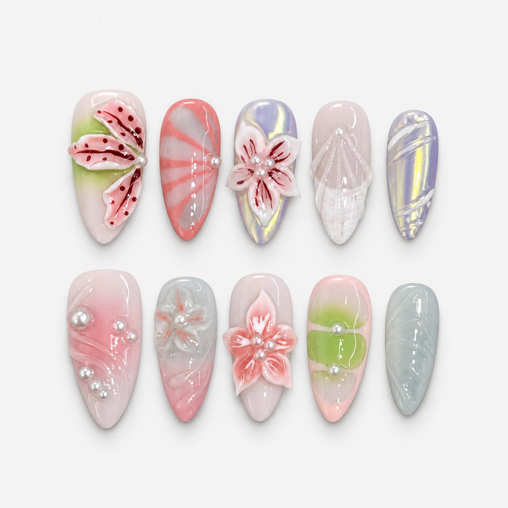 catalog: Long almond press-on nails in milky pink, green and grey with sculpted 3D lilies and blossoms, red painted petal veins and small white pearls.