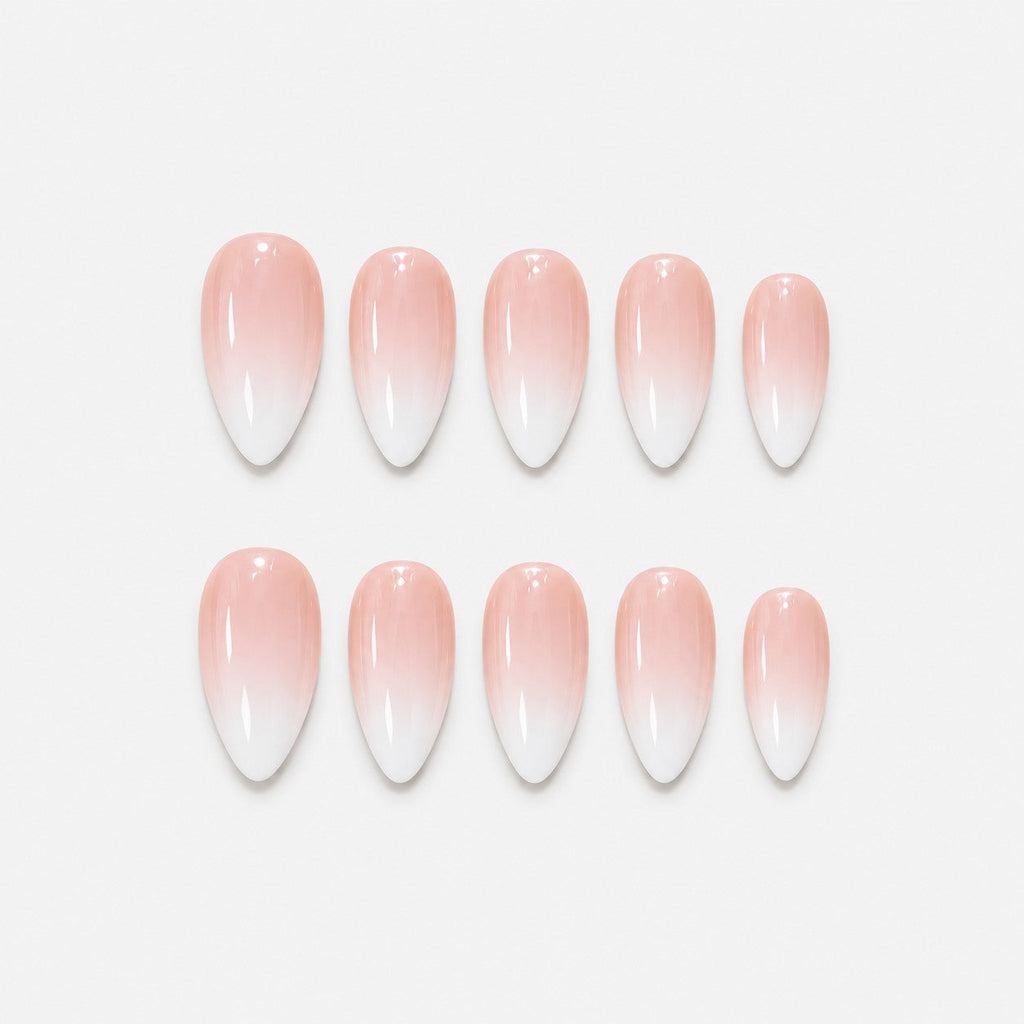 catalog: Medium almond nails in a smooth nude to white ombre with a glossy finish and no added decoration.