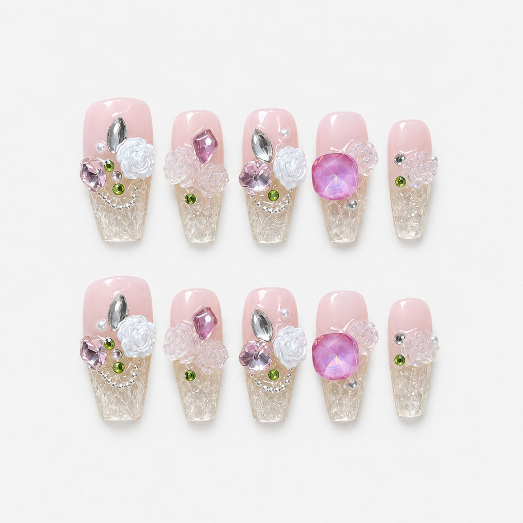 catalog: Long pink and clear coffin nails with white sculpted roses, pink and lilac gems and small green beads.