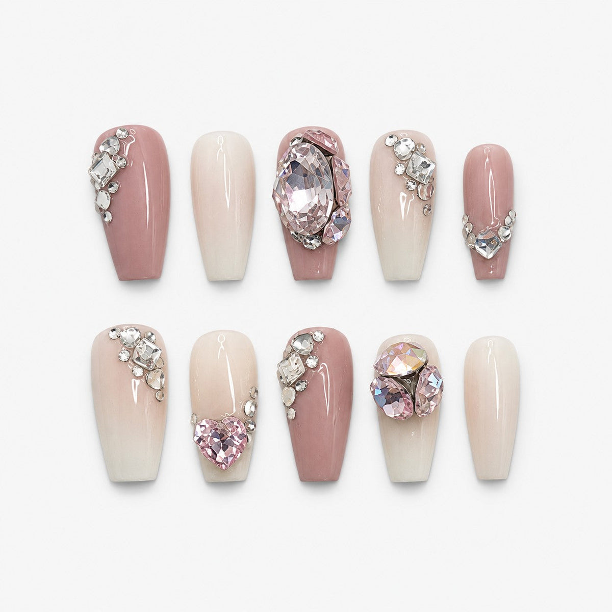 catalog: Long coffin press-on nails in dusty pink and milky cream with clusters of clear crystals and large faceted pink oval and heart gemstones.