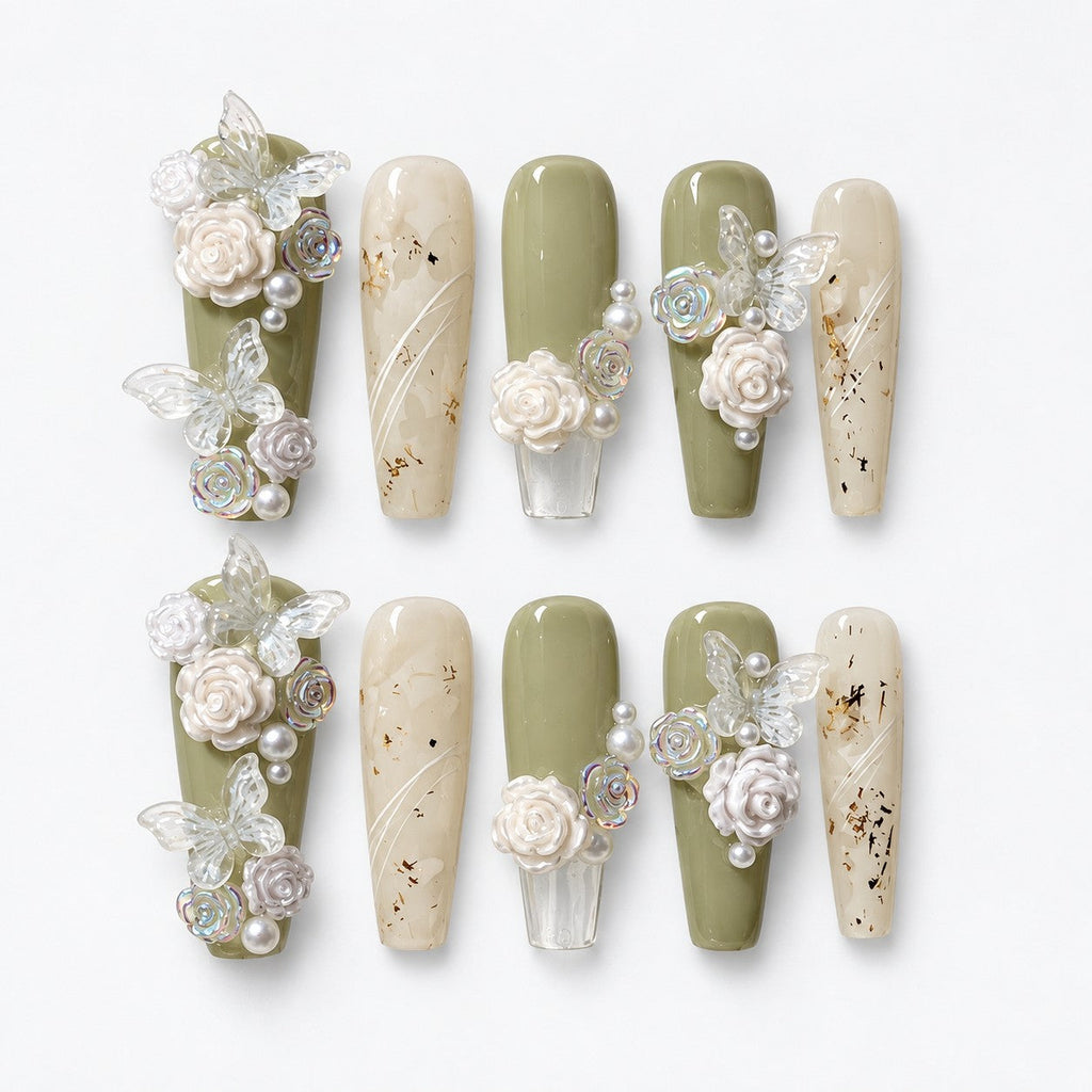 catalog: Long coffin press-on nails in sage green and milky white with hand-sculpted white roses, pearls and sheer butterflies, plus clear nails holding dried flower flecks.