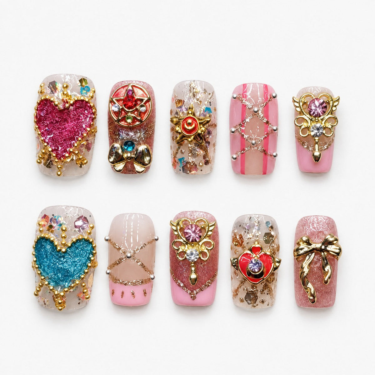 catalog: Medium press-on nails in sheer pink with glittery fuchsia and teal hearts, gold crown and bow charms, crystals, gold flakes and pink stripes.