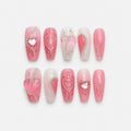 catalog: Long almond press-on nails in pink and milky white with sculpted glossy hearts, iridescent pink stones, silver chains and small crystals.