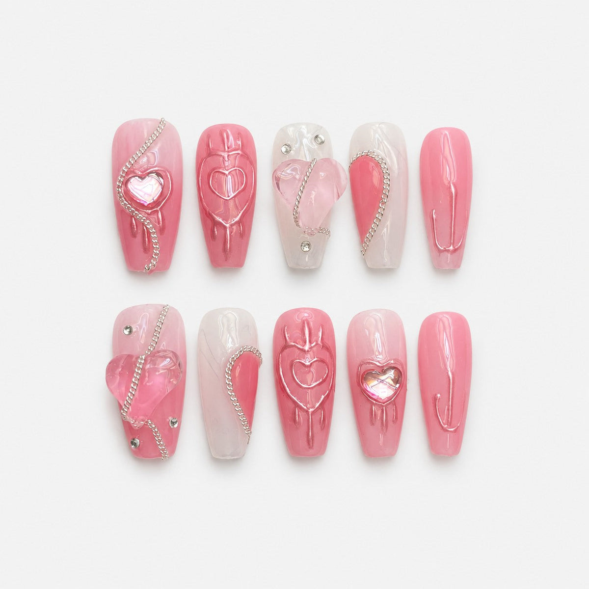 catalog: Long almond press-on nails in pink and milky white with sculpted glossy hearts, iridescent pink stones, silver chains and small crystals.
