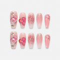 catalog: Long coffin press-on nails in sheer pink with a raised glitter heart, silver beading and crystal grit at the cuticle.