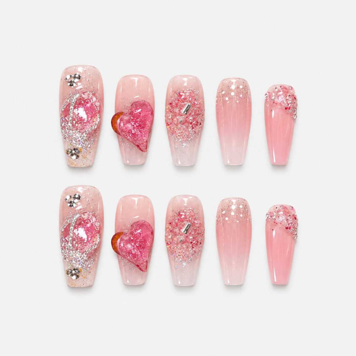 catalog: Long coffin press-on nails in sheer pink with a raised glitter heart, silver beading and crystal grit at the cuticle.