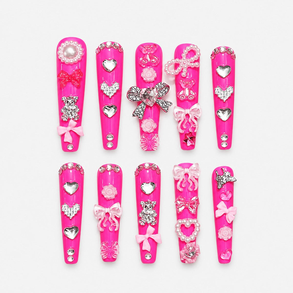 catalog: Long coffin nails in glossy hot pink covered with silver hearts, pearl bows, roses and crystal charms.