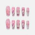 catalog: Long pink coffin nails with iridescent 3D bows, bear charms, glassy hearts and curved pearl strands.