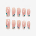 catalog: Long almond nails in milky pink with glossy finish and blue teardrop gems set in silver along the tips.